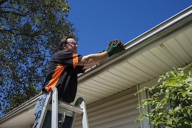 a technician replacing a section of damaged gutter in Altavista, VA